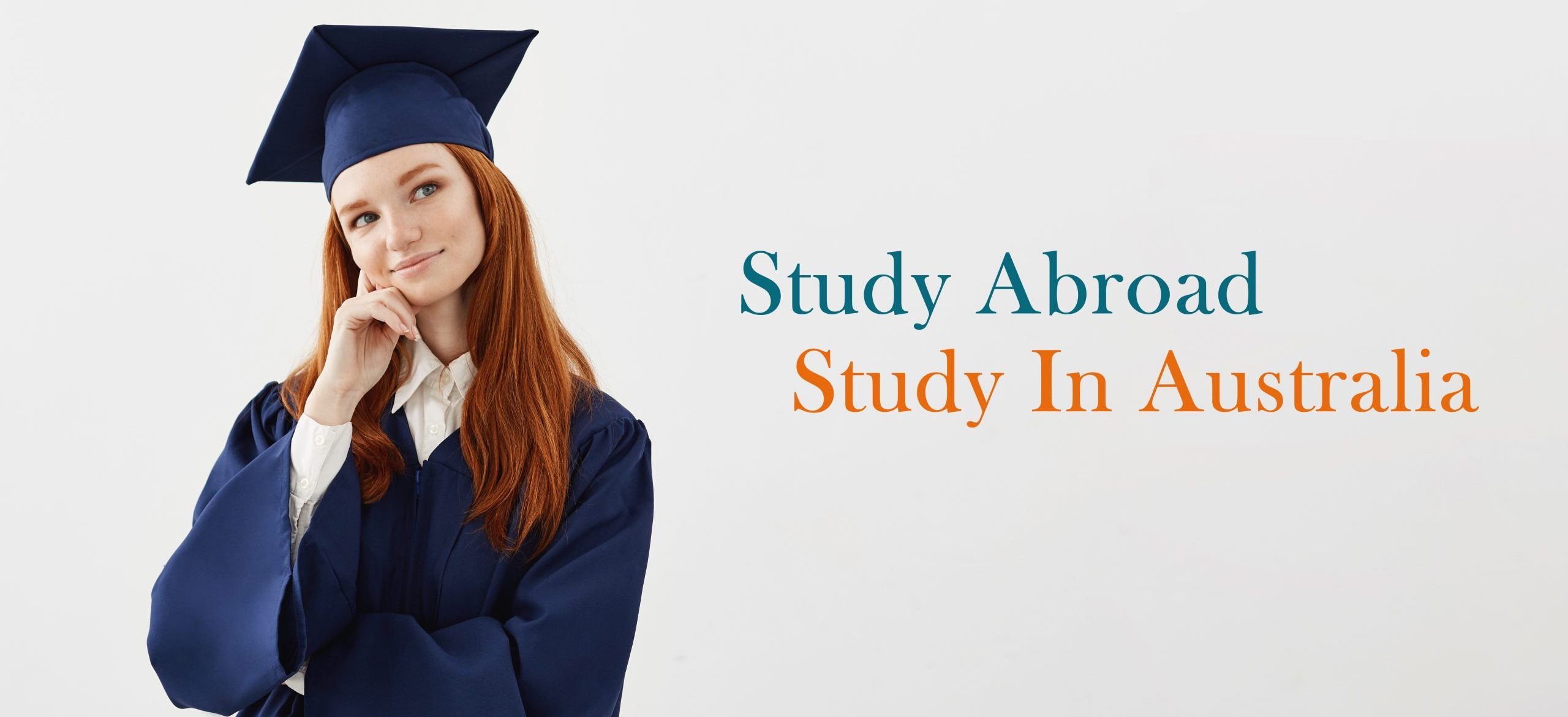 Young female university graduate in academic cap sitting at table smiling pointing left. Future lawyer or engineer showing an idea. White background.